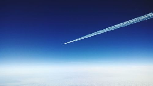 Low angle view vapor trails in sky