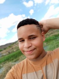 Portrait of smiling boy against sky