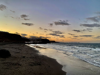 Scenic view of beach against sky during sunset