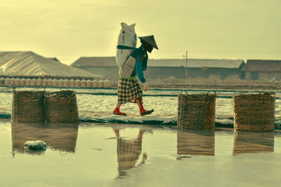 Full length of child at beach against sky