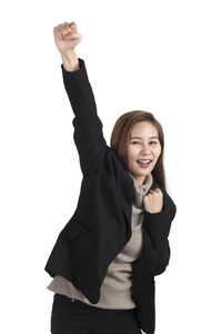Portrait of young woman holding smart phone over white background