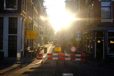 Traffic on road by buildings in city