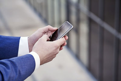 Businessman holding cell phone