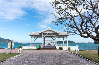 Gazebo by sea against sky