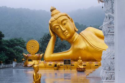 Statue of buddha against trees