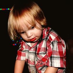 Portrait of cute boy against black background