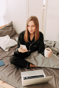 Happy business woman freelancer working chatting on the phone using technology remotely from home