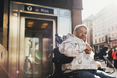 Disabled man on motorized wheelchair in city