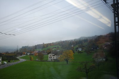 Houses on mountain against sky