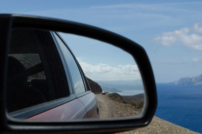 Close-up of side-view mirror of car