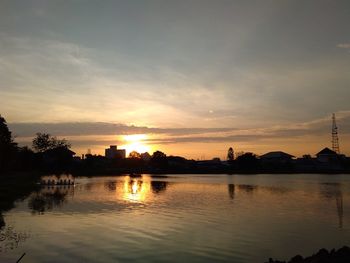 Scenic view of dramatic sky over river during sunset