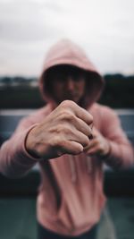 Portrait of man holding cigarette against blurred background