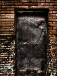 Close-up of window on brick wall