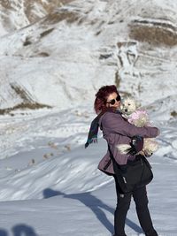 Full length of woman standing on snow