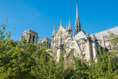 Notre dame de paris - famous cathedral with blue sky before fire april 15, 2019