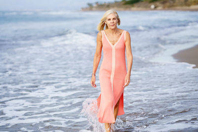 Portrait of woman walking on beach