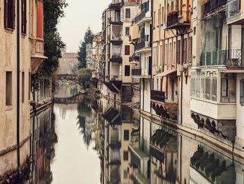 Canal amidst buildings in city