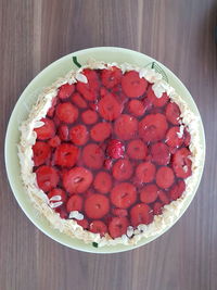 High angle view of cake in plate on wooden table