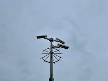 Low angle view of telephone pole against sky