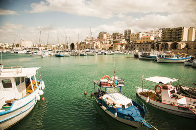 High angle view of boats moored at harbor against sky