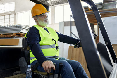 Worker on forklift in factory