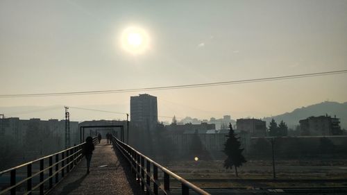 View of bridge in city against sky during sunset