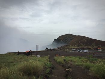 Scenic view of mountains against cloudy sky