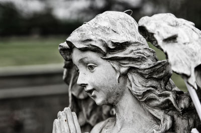 Close-up of angel statue in cemetery