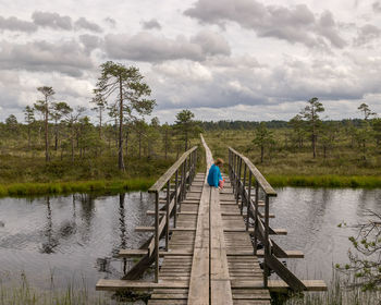 Pier over lake against sky