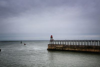 Pier on sea against sky