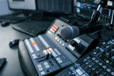 Close up view of radio mixing desk with professional sound equipment.