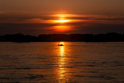 Scenic view of sea against orange sky