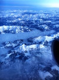 Aerial view of airplane wing over landscape