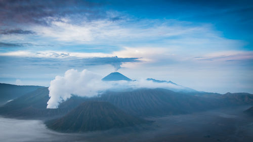 View of volcanic landscape against cloudy sky