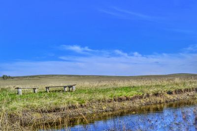 View of rural landscape against blue sky
