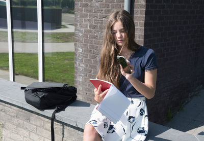 Portrait of young woman using mobile phone