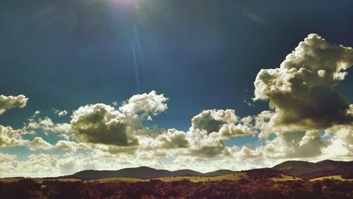 Scenic view of mountains against cloudy sky
