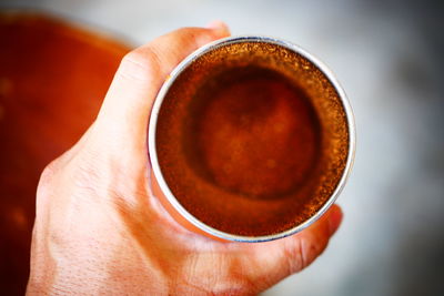 Close-up of hand holding coffee cup