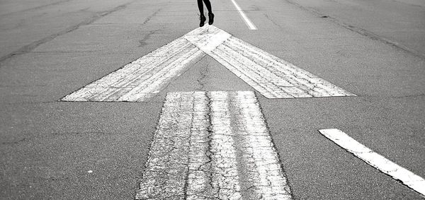 High angle view of arrow symbol on road