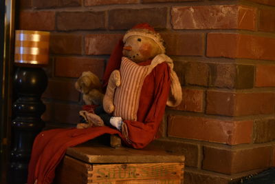 Boy sitting on brick wall