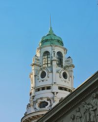 Low angle view of building against clear blue sky