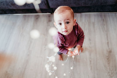 Cute smiling baby girl with decoration at home