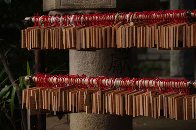 Close-up of clothespins hanging on railing