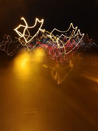 Close-up of light trails against sky at night