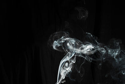 Close-up of smoke emitting from black background