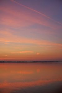 Scenic view of sea against romantic sky at sunset