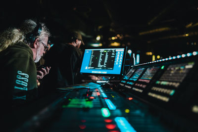 Side view of people working at night