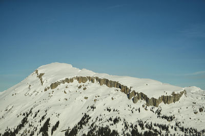 Scenic view of snowcapped mountains against clear sky