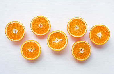 High angle view of orange fruits against white background