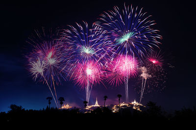 Firework display against sky at night